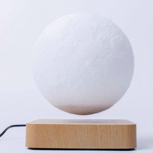 Levitating moon lamp floating in mid-air on wooden base